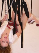 Blonde virgin in a tight ball gagg and securely bound in spreader bar and with neck bar
