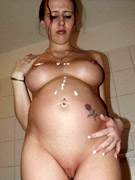 Pretty pregnant lady playing with her large breasts and having some fun with a glassy toy
