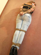 Gag taped blonde chick in jeans gets hogtied and dropped facedown to the floor