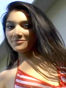 Cute brunette teen gal posing in striped bikini at the beach