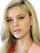 Hot blondie nicola peltz shows more skin in her orange and pink short dress while revealing her hot cleavage.
