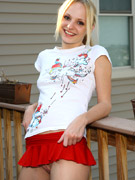 Nasty blonde teen doll in a black bra and leggings posing
