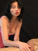 Woman in seductive pink langerie teasingly playing a cock to squirt