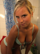 Tanned ponytailed blonde freshie with awesome form taking bath