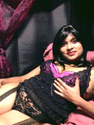 Stunning indian brunette posing on the bed in her sexy black lingerie.