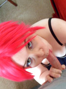 Young babe with bright red hair shows off body in gray lingerie and smothers cock with her mouth.